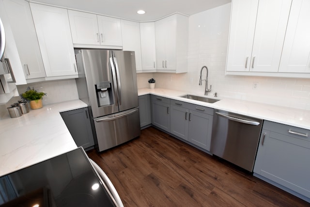 kitchen featuring white cabinetry, sink, gray cabinets, and stainless steel appliances