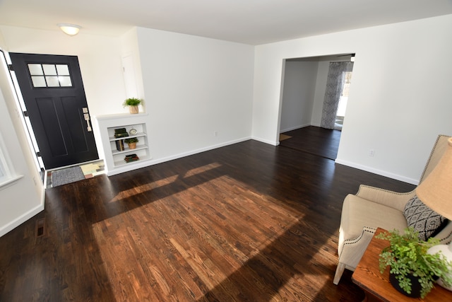 entryway with dark hardwood / wood-style flooring