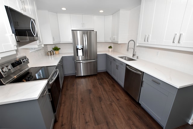 kitchen featuring gray cabinetry, sink, white cabinetry, and appliances with stainless steel finishes