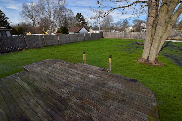 wooden terrace featuring a yard