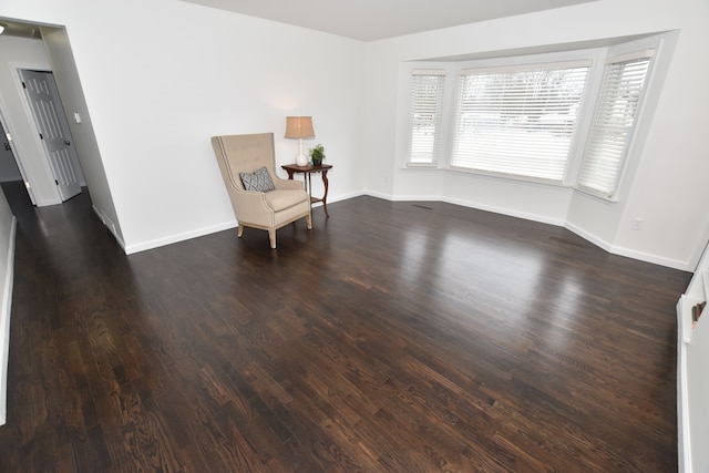 unfurnished room with dark hardwood / wood-style flooring