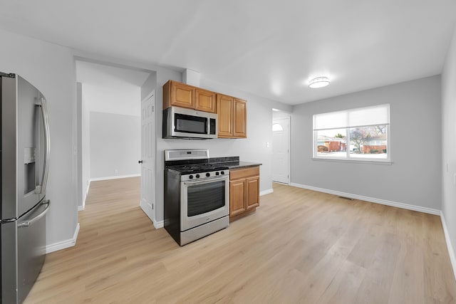 kitchen featuring stainless steel appliances and light hardwood / wood-style floors