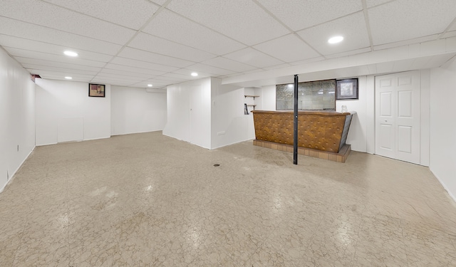 basement with a paneled ceiling