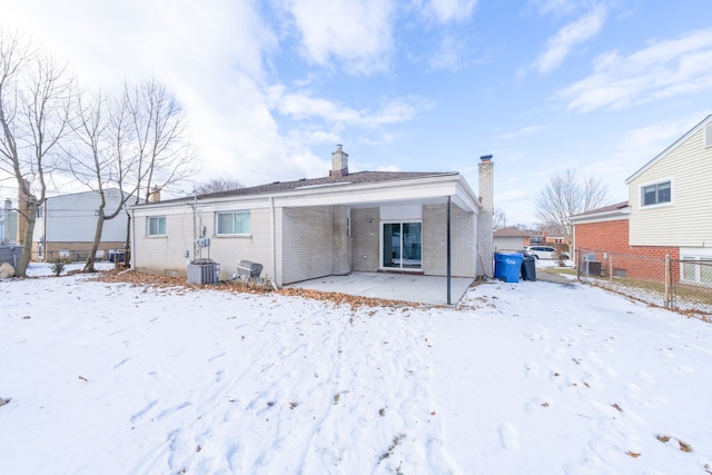 snow covered house with cooling unit