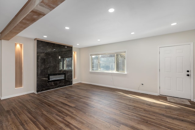 unfurnished living room with dark hardwood / wood-style floors and a fireplace