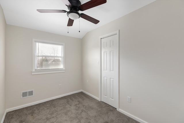 spare room featuring light carpet and ceiling fan