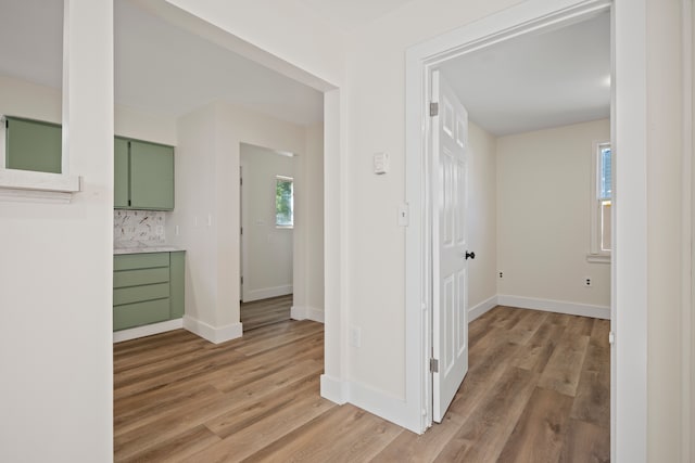 corridor with light hardwood / wood-style floors