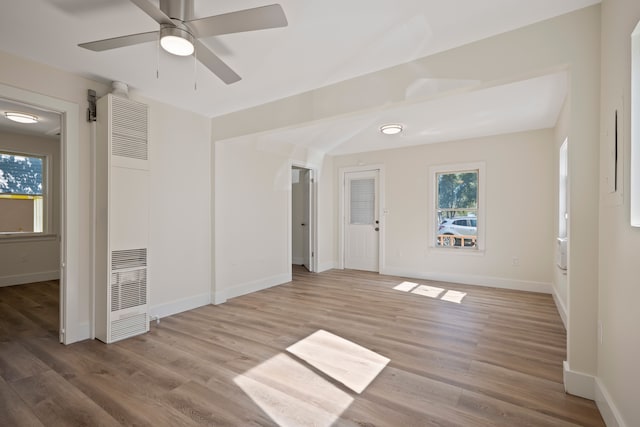 spare room with ceiling fan and light wood-type flooring