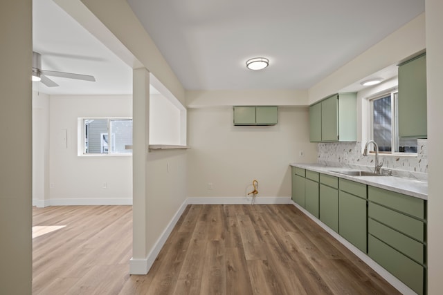 kitchen featuring tasteful backsplash, sink, plenty of natural light, and green cabinets