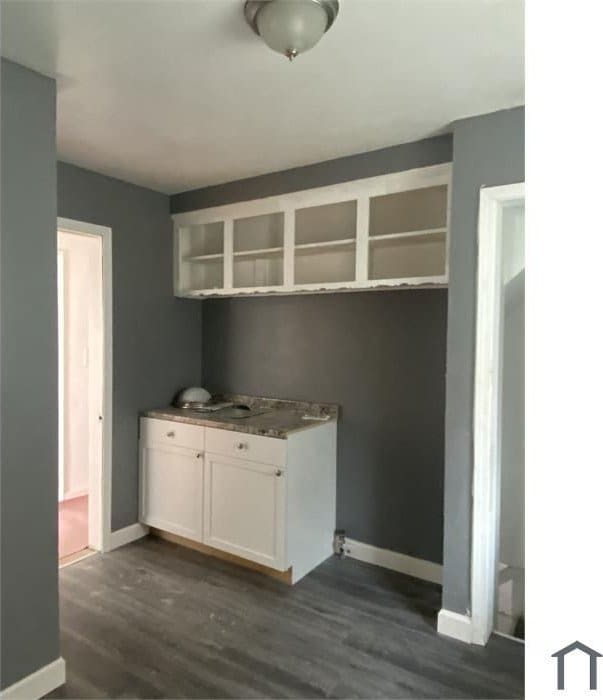 laundry area with dark hardwood / wood-style floors