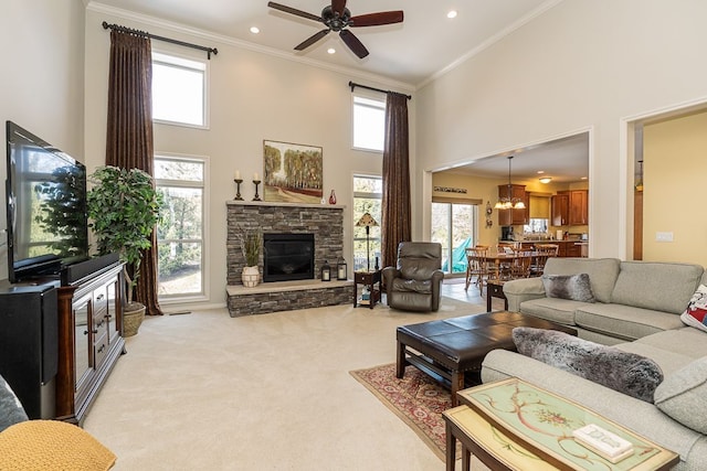 living room featuring crown molding, a stone fireplace, and a wealth of natural light