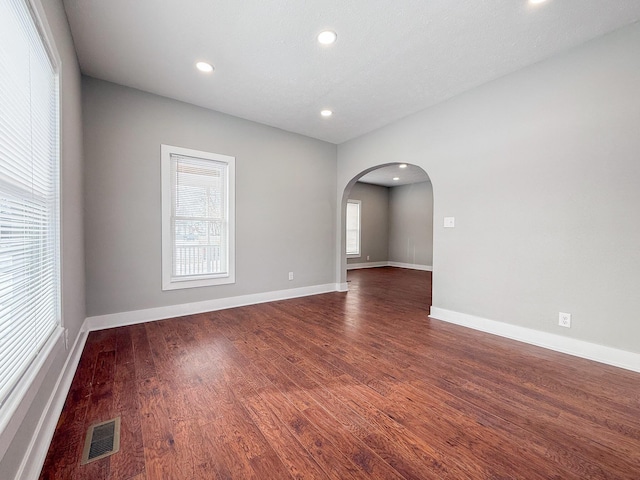 spare room with dark hardwood / wood-style flooring