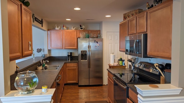 kitchen featuring appliances with stainless steel finishes, dark hardwood / wood-style flooring, and sink