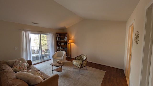 living area featuring dark wood-type flooring and lofted ceiling