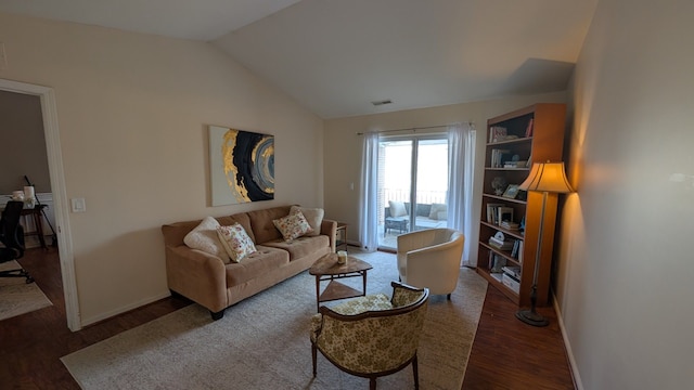 living room with vaulted ceiling and dark wood-type flooring