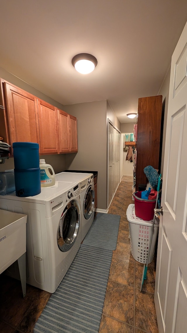 laundry area with cabinets, separate washer and dryer, and sink