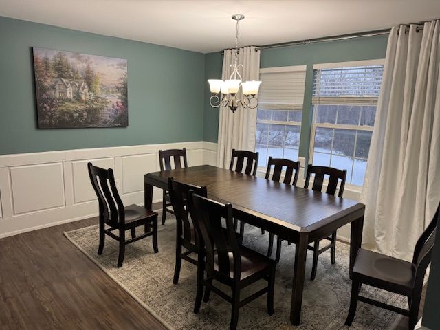 dining room featuring dark hardwood / wood-style floors and a chandelier