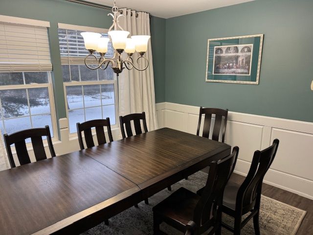 dining area with hardwood / wood-style floors and a chandelier