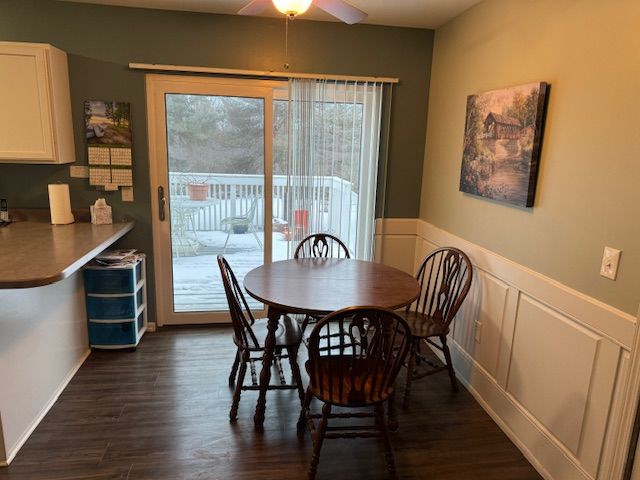 dining area with dark hardwood / wood-style floors and ceiling fan