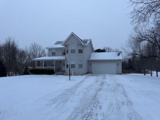 view of front property featuring a garage and a porch