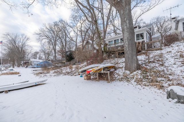 yard layered in snow featuring a deck