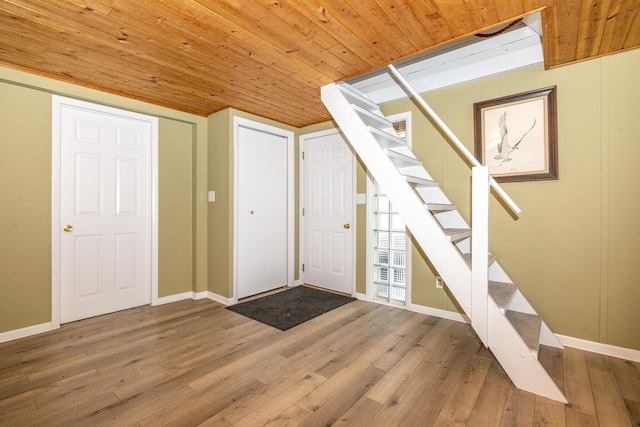 entryway with hardwood / wood-style flooring and wooden ceiling