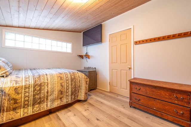 bedroom featuring vaulted ceiling, light hardwood / wood-style floors, and wooden ceiling