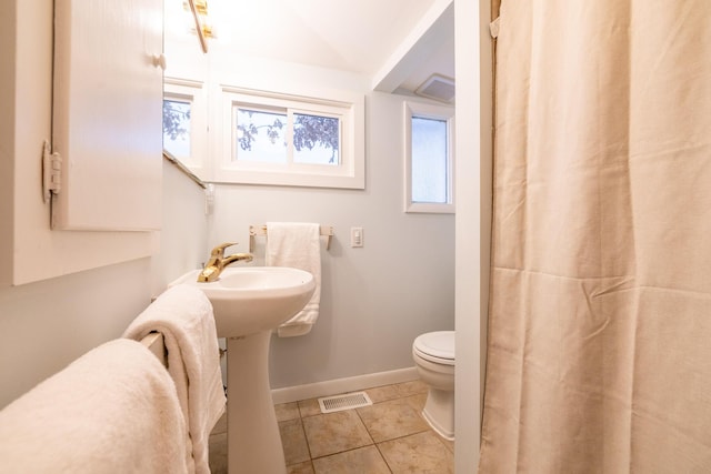 bathroom featuring tile patterned flooring and toilet