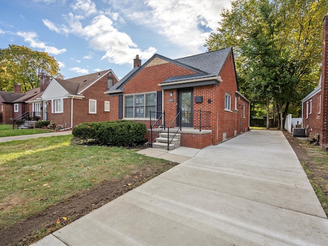 bungalow-style home featuring a front yard and central air condition unit