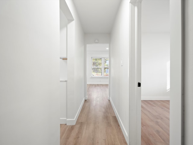 hallway with light hardwood / wood-style floors