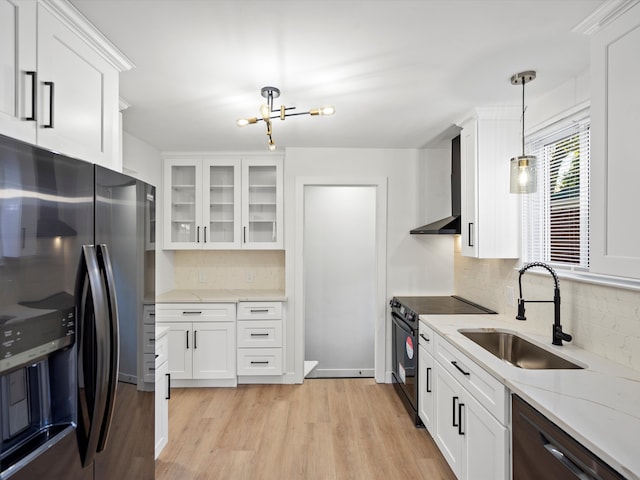 kitchen with sink, white cabinetry, stainless steel refrigerator with ice dispenser, black electric range, and decorative light fixtures