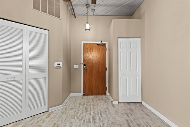 foyer entrance with light hardwood / wood-style flooring