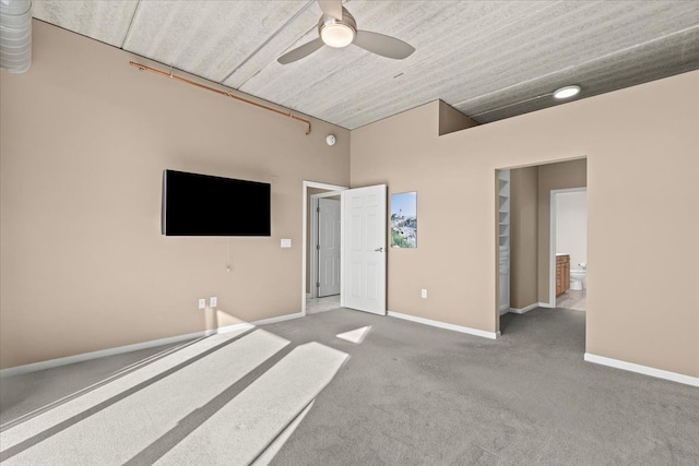 unfurnished bedroom with ceiling fan, connected bathroom, and carpet floors