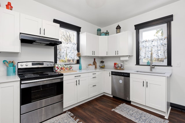 kitchen with white cabinetry, sink, dark wood-type flooring, and appliances with stainless steel finishes