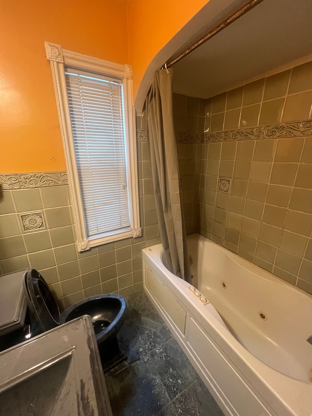 bathroom with tile walls, shower / bath combo, and toilet