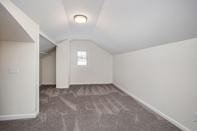 bonus room featuring lofted ceiling and carpet floors