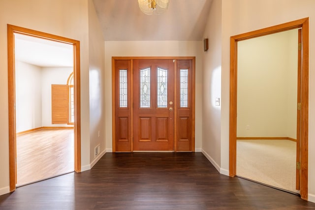 foyer featuring dark wood-type flooring and lofted ceiling