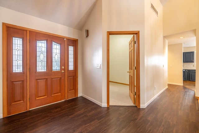 entryway featuring dark wood-type flooring and high vaulted ceiling