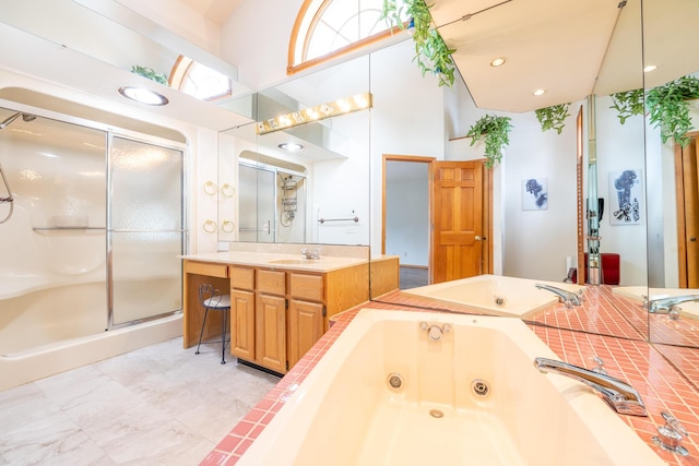 bathroom with vanity and shower with separate bathtub