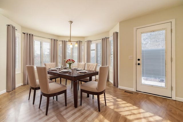 dining area featuring light parquet flooring