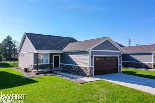 view of front of property featuring a garage and a front lawn