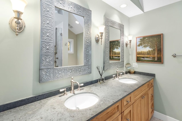 bathroom featuring vanity and lofted ceiling