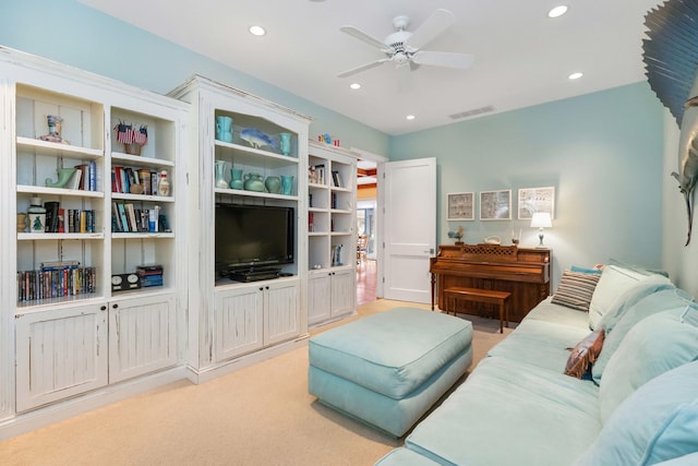 carpeted living room featuring ceiling fan