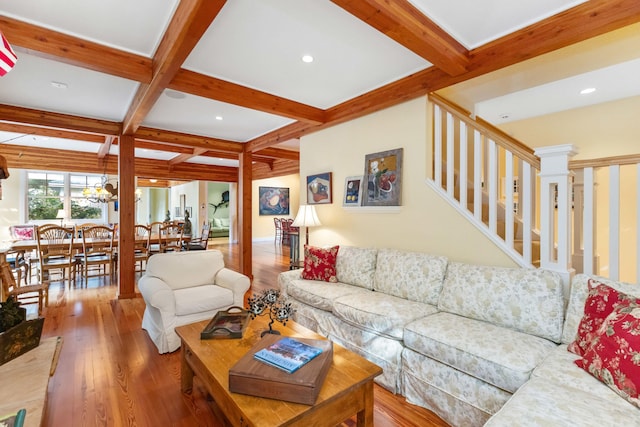 living room featuring coffered ceiling, a notable chandelier, hardwood / wood-style flooring, and beamed ceiling