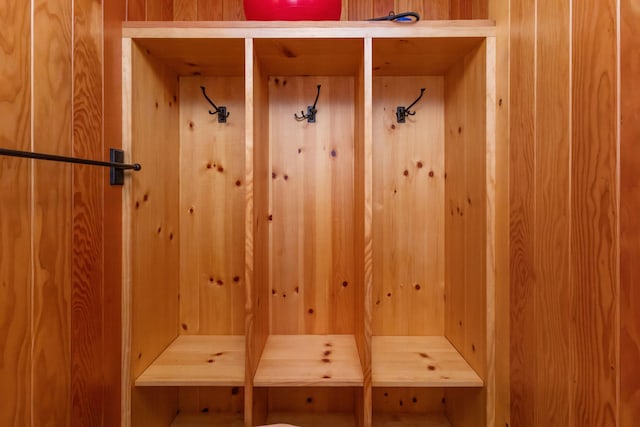 mudroom with wood walls