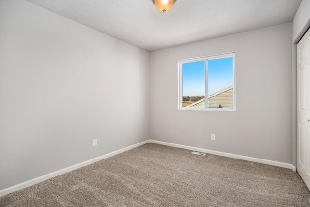 unfurnished room with carpet floors