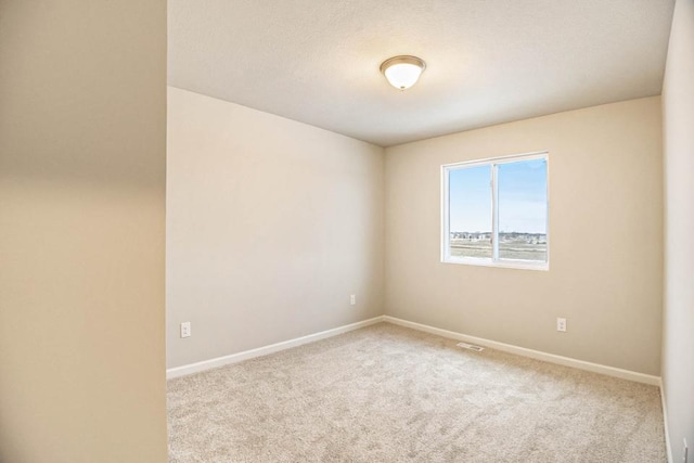 spare room with light colored carpet