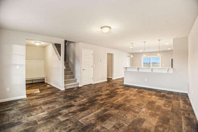 unfurnished living room with dark wood-type flooring