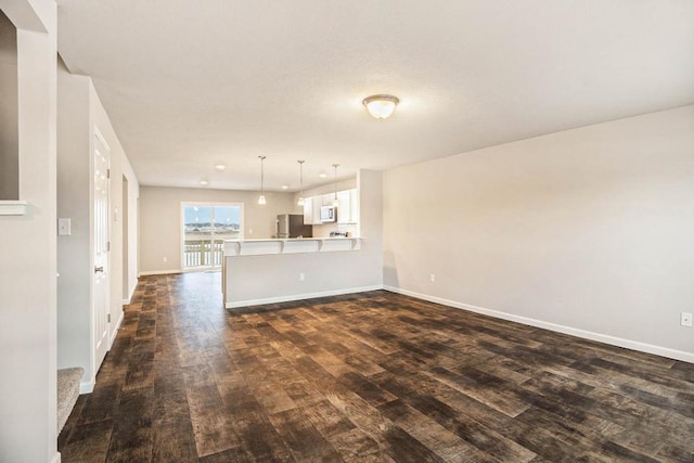 unfurnished living room with dark hardwood / wood-style flooring