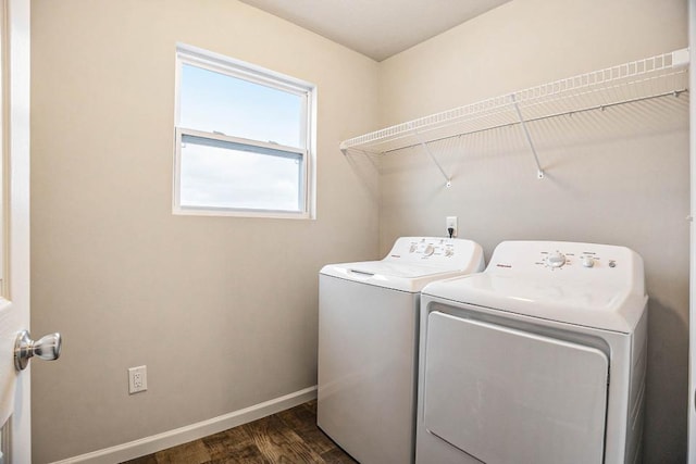 laundry room featuring washing machine and dryer and dark hardwood / wood-style floors